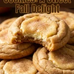 Soft apple cider cookies topped with a creamy cheesecake frosting swirl and a sprinkle of cinnamon on a plate.