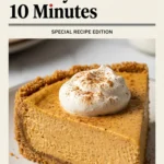 A slice of no-bake pumpkin cheesecake with a graham cracker crust, topped with whipped cream and a cinnamon stick.