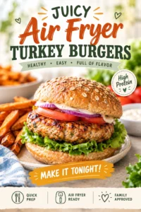 Two juicy air fryer turkey burgers on toasted buns with melted cheese, lettuce, tomato, and onion on a plate.