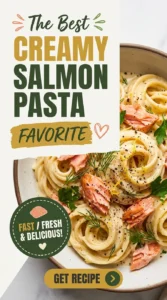Fettuccine pasta in a creamy white sauce with flakes of hot smoked salmon and fresh parsley in a bowl.