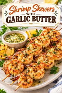 Grilled shrimp skewers glazed in garlic butter, garnished with fresh parsley and lemon wedges on a dark platter.