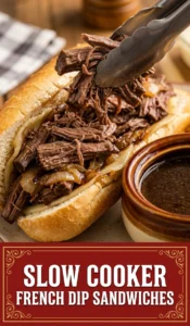 Two toasted French dip sandwiches with roast beef and melted cheese, served with a small bowl of savory au jus.