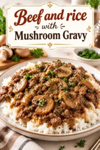 A bowl of tender beef chunks and white rice topped with a rich, brown mushroom gravy and fresh parsley.